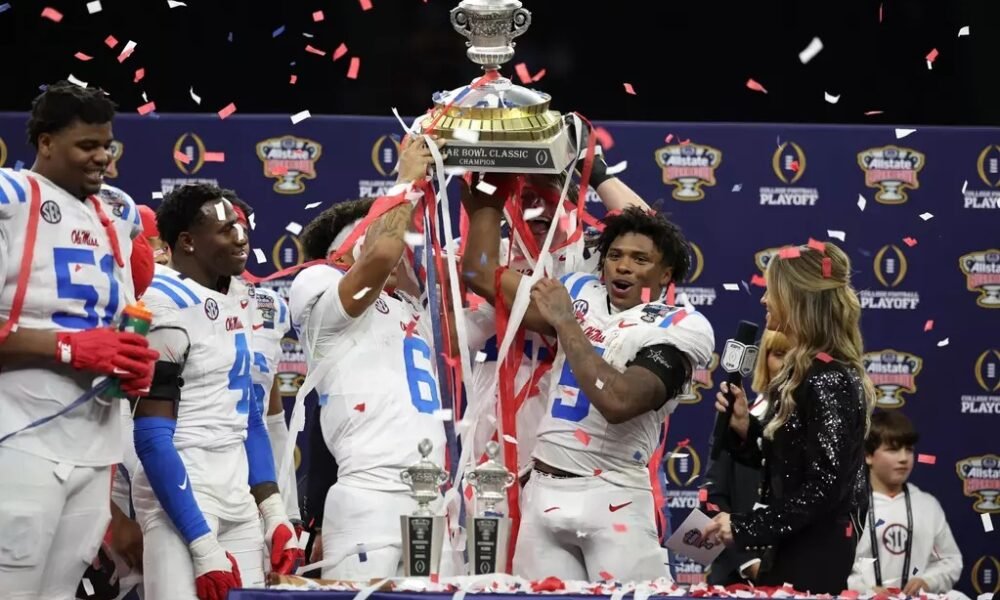 Ole Miss players celebrate with the Sugar Bowl trophy after defeating Georgia 39-34. | Ole Miss Athletics