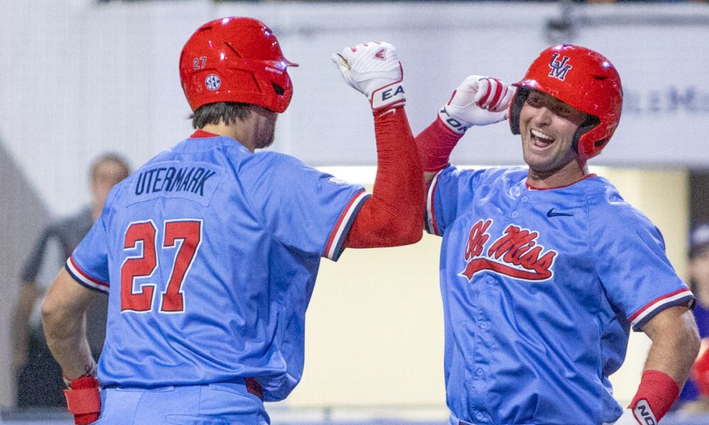 Ole Miss third baseman Judd Utermark, left, celebrates a pair of runs scored with Will Furniss during Wednesday's game against North Alabama. | Dylan Cohron, HottyToddy.com