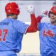 Ole Miss third baseman Judd Utermark, left, celebrates a pair of runs scored with Will Furniss during Wednesday's game against North Alabama. | Dylan Cohron, HottyToddy.com