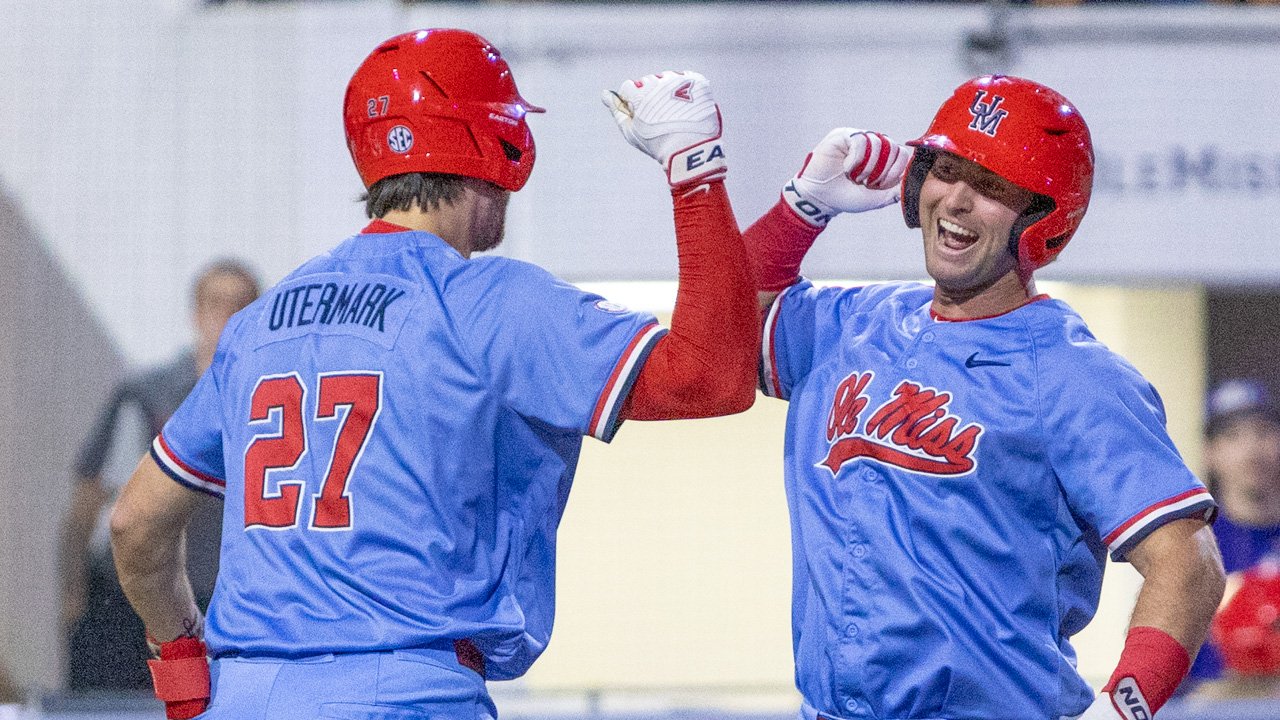 Ole Miss third baseman Judd Utermark, left, celebrates a pair of runs scored with Will Furniss during Wednesday's game against North Alabama. | Dylan Cohron, HottyToddy.com