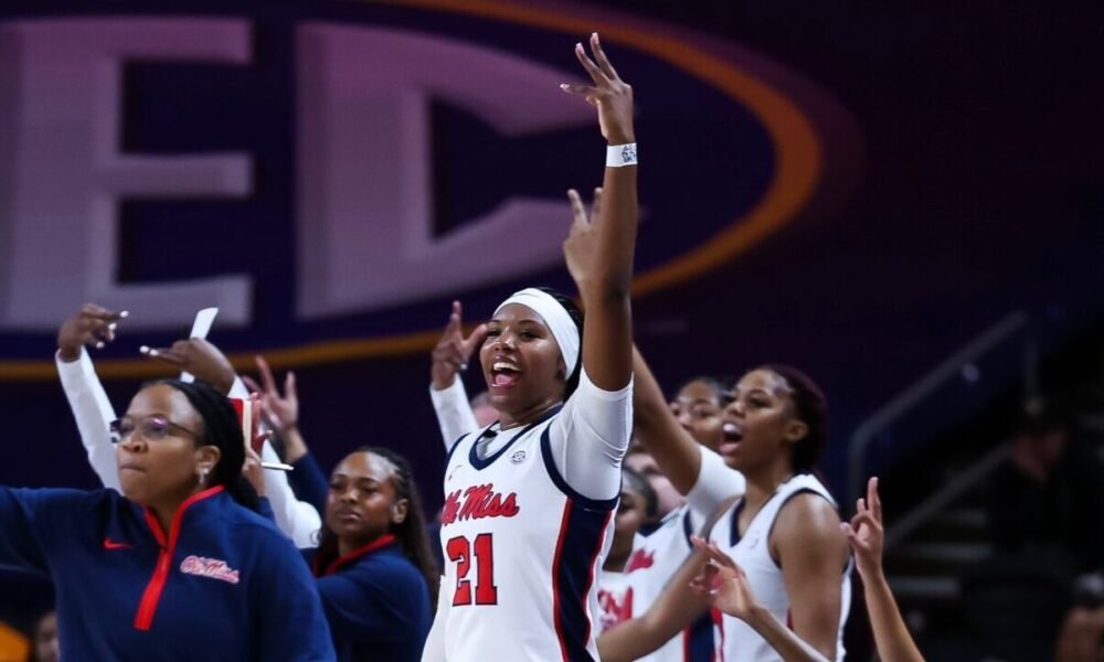 Ole Miss women's basketball coaches and players celebrate a three-pointer in the first half of an SEC Tournament first-round game. | Ole Miss Athletics