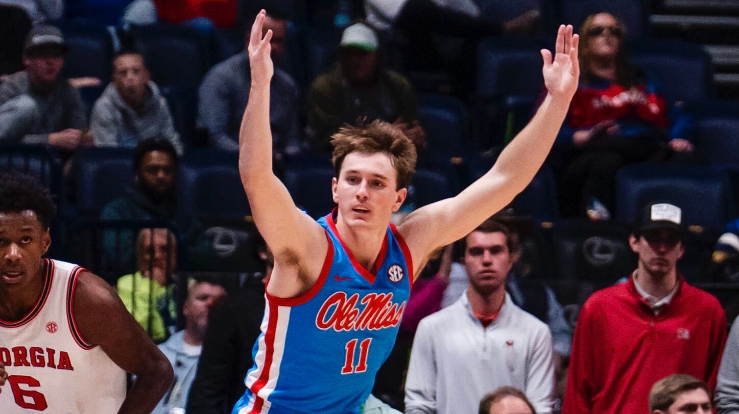 Ole Miss guard Travis Perry raises his arms in celebration after making a three pointer in Thursday's SEC Tournament win against Georgia. | Ole Miss Athletics