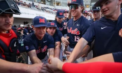 Ole Miss baseball players and coach Mike Bianco huddle before the start of a game against No. 15 Kentucky. | Ole Miss Athletics