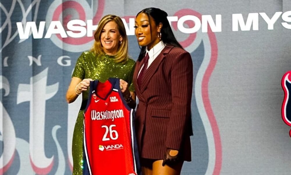 WNBA commissioner Cathy Engelbert poses for photos with former Ole Miss guard Cotie McMahon after announcing McMahon's draft selection by the Washington Mystics. | Ole Miss Athletics