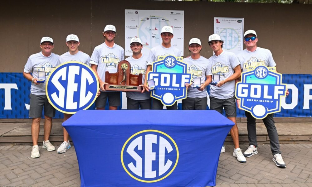 Ole Miss men's golf team poses for photos with the 2026 SEC championship trophy and medals. | Ole Miss Athletics