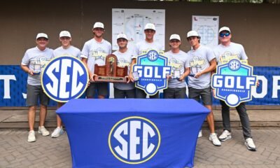 Ole Miss men's golf team poses for photos with the 2026 SEC championship trophy and medals. | Ole Miss Athletics