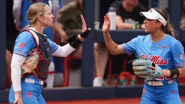 Ole Miss softball players high five during Sunday's game against No. 13 Texas A&M in Osxford. | Ole Miss Athletics