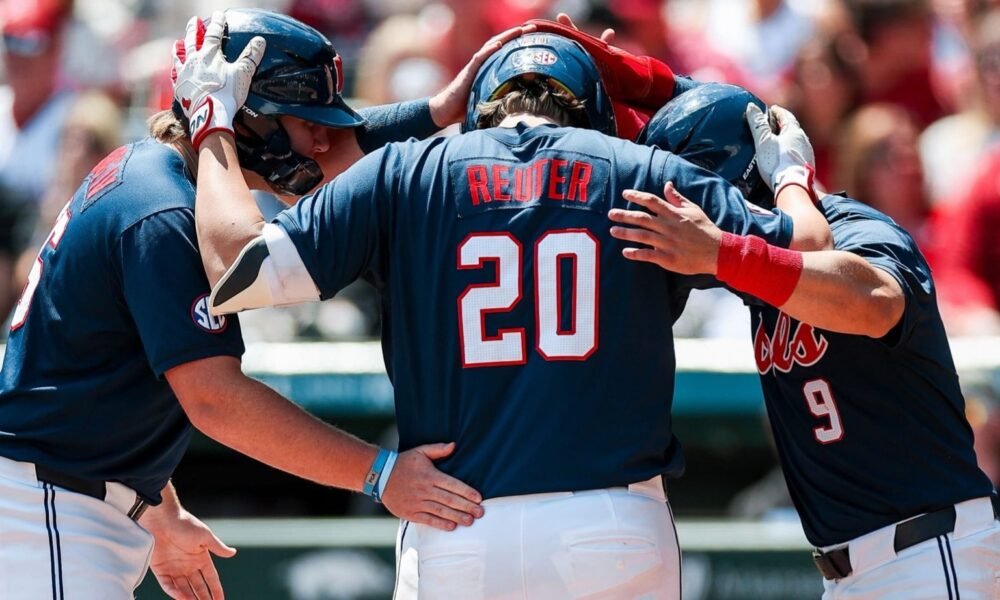 Ole Miss DH Collin Reuter celebrates his home run with Will Furniss and Hayden Federico in Saturday's win against No. 22 Arkansas. | Ole Miss Athletics