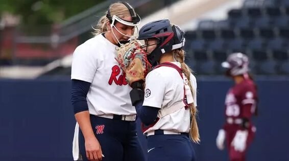 Ole Miss pitcher Emilee Boyer and catcher Kennedy Bunker talk strategy during an SEC game against Mississippi State. | Ole Miss Athletics